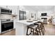 Modern kitchen with an island, stainless appliances, and a view into the living room at 3882 The Ascent Ne, Brookhaven, GA 30319