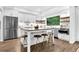 Bright, spacious kitchen features stainless steel appliances, a large island with seating, and wood flooring at 3882 The Ascent Ne, Brookhaven, GA 30319