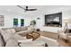 Cozy living room with a large sectional couch, modern entertainment center and wood grain floors at 3882 The Ascent Ne, Brookhaven, GA 30319