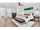 Spacious bedroom with natural light, bench seat, and ensuite bathroom behind sliding door at 3882 The Ascent Ne, Brookhaven, GA 30319