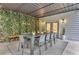 Stylish covered patio featuring dining, and a chic green vine wall, perfect for outdoor gatherings at 3882 The Ascent Ne, Brookhaven, GA 30319
