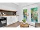 Cozy sitting area with coffee bar and french doors leading to private balcony with natural light at 3882 The Ascent Ne, Brookhaven, GA 30319