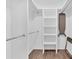 Custom walk-in closet with chrome shelving and ample space for storage with hardwood style floors at 3882 The Ascent Ne, Brookhaven, GA 30319