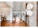 Welcoming foyer with hardwood floors, high ceilings, decorative trim, and a clear view into the home at 7010 Wakehurst Pl, Cumming, GA 30040