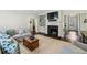 Cozy living room featuring a fireplace, built-in shelving, and comfortable seating with hardwood floors at 1025 Dawn View Nw Ln, Atlanta, GA 30327