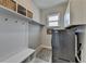 Functional mudroom featuring built-in storage, coat hooks, and a stylish patterned rug at 3820 Reserve Overlook Way, Cumming, GA 30041