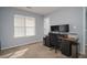 Bright bedroom featuring a large window, neutral carpet, and a functional desk area with dual monitors at 5381 Briar Creek Ln, Norcross, GA 30071