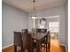 Dining room with hardwood floors, a modern light fixture, and view of a living room at 5381 Briar Creek Ln, Norcross, GA 30071