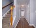 Inviting hallway featuring hardwood floors, neutral paint, and a staircase at 5381 Briar Creek Ln, Norcross, GA 30071