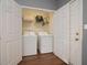 Convenient laundry closet equipped with a washer, dryer and wire shelving at 5381 Briar Creek Ln, Norcross, GA 30071
