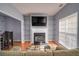 Cozy living room featuring a fireplace with glass shelving, hardwood floors and lots of natural light at 5381 Briar Creek Ln, Norcross, GA 30071