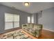 Comfortable living room with hardwood floors and bright natural light from large windows at 5381 Briar Creek Ln, Norcross, GA 30071