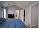 Main bedroom with vaulted ceiling, blue bedding, and access to a closet and ensuite bathroom at 5381 Briar Creek Ln, Norcross, GA 30071