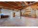 Unfinished basement area with exposed ceiling beams and natural lighting at 305 Bridgewater Ter, Canton, GA 30115