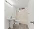 Clean bathroom with a pedestal sink, wood-look flooring, and a shower-tub combo at 305 Bridgewater Ter, Canton, GA 30115