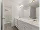 Well-lit bathroom featuring a double vanity, a large mirror, and a separate walk-in shower at 305 Bridgewater Ter, Canton, GA 30115