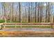 Wood bench seating on the deck in a backyard with trees and natural setting at 305 Bridgewater Ter, Canton, GA 30115