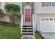 Close-up of the front door, entry stairs, and a partial view of the 2-car garage at 305 Bridgewater Ter, Canton, GA 30115