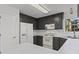 Updated kitchen with sleek grey cabinets, white appliances, and bright white countertops at 305 Bridgewater Ter, Canton, GA 30115