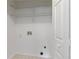 Bright laundry room with white walls, tile flooring, and wire shelving for optimal organization at 305 Bridgewater Ter, Canton, GA 30115