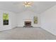 Comfortable living room featuring a fireplace and large windows, perfect for relaxation at 305 Bridgewater Ter, Canton, GA 30115