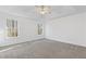 Spacious main bedroom featuring plush carpeting, tray ceiling, ceiling fan, and large windows at 305 Bridgewater Ter, Canton, GA 30115