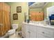 Hall bathroom featuring neutral green walls, white vanity and a golden shower curtain at 4040 Annecy Dr, Atlanta, GA 30331
