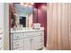 A white bathroom vanity with a mirror and good lighting at 4040 Annecy Dr, Atlanta, GA 30331