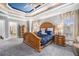 A cozy bedroom with an intricate ceiling, a large bed, and a set of windows at 4040 Annecy Dr, Atlanta, GA 30331