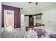 View of the bedroom featuring purple accent wall and ensuite bathroom entrance at 4040 Annecy Dr, Atlanta, GA 30331