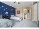 Bedroom featuring two twin beds and an ensuite bathroom with blue accent wall at 4040 Annecy Dr, Atlanta, GA 30331