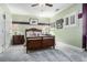 A bedroom featuring green walls, a wooden bed frame, and soft, gray carpeting at 4040 Annecy Dr, Atlanta, GA 30331