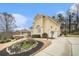 Elegant, multi-story home with a curved driveway, manicured landscaping, and attached two-car garage at 4040 Annecy Dr, Atlanta, GA 30331