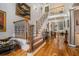 Open foyer with hardwood floors, staircase with iron railings, and a view into the living room at 4040 Annecy Dr, Atlanta, GA 30331