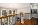 Second story foyer overlooking the living room with large windows and a chandelier at 4040 Annecy Dr, Atlanta, GA 30331