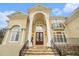 Close up of a grand entrance with stone steps leading to a double door entry and a balcony at 4040 Annecy Dr, Atlanta, GA 30331