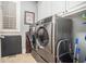 A well-equipped laundry room showcases a modern washer and dryer, paired with practical storage cabinets at 4040 Annecy Dr, Atlanta, GA 30331