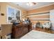 Home office with striped walls and a ceiling fan has hardwood floors and large window for natural light at 4040 Annecy Dr, Atlanta, GA 30331