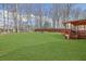 Large, well-maintained backyard featuring green grass, a firepit area, and a covered patio for entertaining at 618 Jenmarie Sw Dr, Mableton, GA 30126