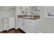 Bathroom with white vanity and dark countertops, complemented by a white storage cabinet at 618 Jenmarie Sw Dr, Mableton, GA 30126