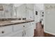 Bright bathroom with a white vanity, decorative mirror, and nautical-themed shower curtain at 618 Jenmarie Sw Dr, Mableton, GA 30126