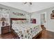 Comfortable bedroom with a tray ceiling, hardwood floors, and views into ensuite bathroom at 618 Jenmarie Sw Dr, Mableton, GA 30126
