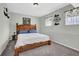 Cozy bedroom with a wooden bed frame, soft carpet, and natural light from the windows at 618 Jenmarie Sw Dr, Mableton, GA 30126