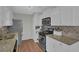 Stylish kitchen with stainless steel appliances, granite counters, and white cabinetry, functional layout at 618 Jenmarie Sw Dr, Mableton, GA 30126