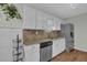 Modern kitchen with stainless steel appliances, white cabinets, and granite countertops, ideal for cooking at 618 Jenmarie Sw Dr, Mableton, GA 30126