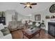Comfortable living room with hardwood floors, fireplace, neutral decor, and abundant natural light at 618 Jenmarie Sw Dr, Mableton, GA 30126