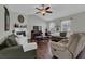 Inviting living room with vaulted ceilings, cozy fireplace, ceiling fan, and hardwood floors at 618 Jenmarie Sw Dr, Mableton, GA 30126