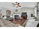 Spacious living room with a fireplace, neutral walls, ceiling fan, and plush furniture at 618 Jenmarie Sw Dr, Mableton, GA 30126