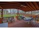 Inviting covered patio with a hammock, grill, dining set, and wood-paneled ceiling for outdoor relaxation at 618 Jenmarie Sw Dr, Mableton, GA 30126