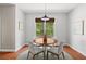 Cozy breakfast nook featuring a round wooden table, seating for four and a window view of outdoor greenery at 2742 Oak Village Trl, Decatur, GA 30032